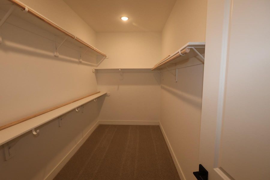 Primary walk-in closet Primary walk-in closet