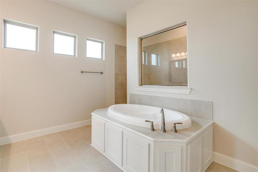 Bathroom featuring a bathing tub and tile patterned floors