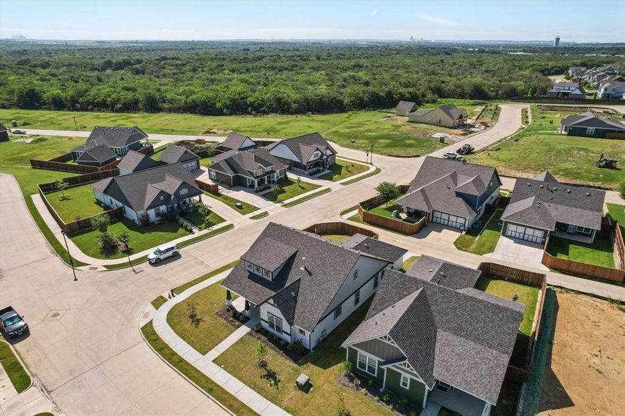 Aerial perspective of suburban area featuring a forest