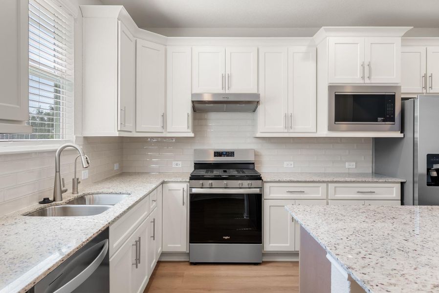 Culinary delights await in this bright kitchen with ample counter space and modern fixtures. Culinary delights await in this bright kitchen with ample counter space and modern fixtures.