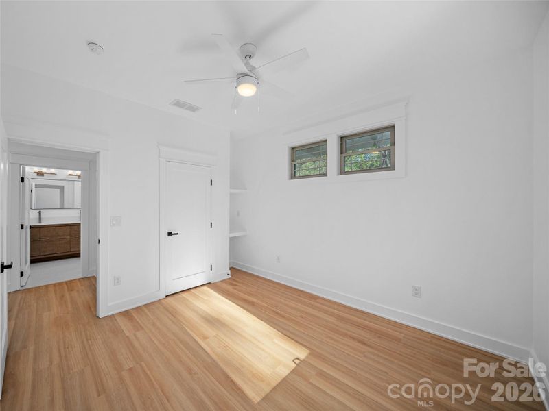 Upper level guest bedroom with door open to hall bath.