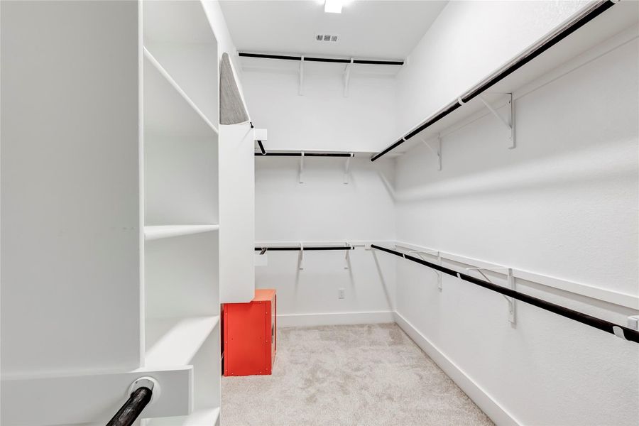 A well-organized closet offers ample storage with integrated shelving and hanging rods.