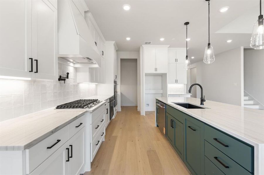 Beautiful cabinetry, gorgeous countertops and designer backsplash paired with contemporary stainless steel creates a chef's kitchen for the ages!