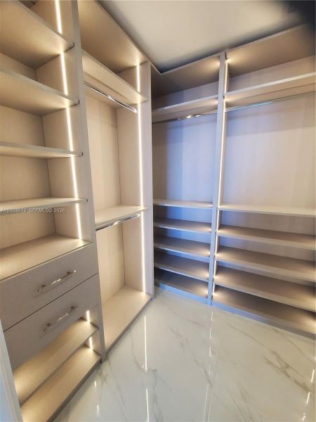 Designer walk in closet with lights