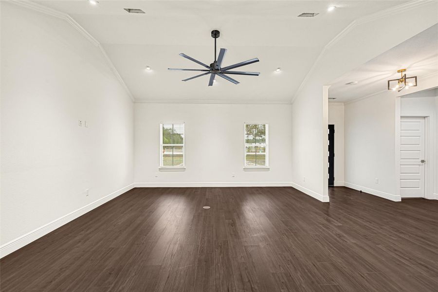 This spacious room features a modern ceiling fan, hardwood floors, and two large windows providing ample natural light. The neutral walls and open layout offer a versatile space for your personal touch. This spacious room features a modern ceiling fan, hardwood floors, and two large windows providing ample natural light. The neutral walls and open layout offer a versatile space for your personal touch.