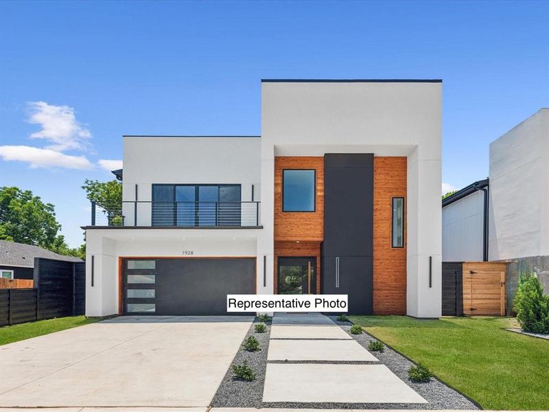 Modern home with a front yard, a garage, and a balcony