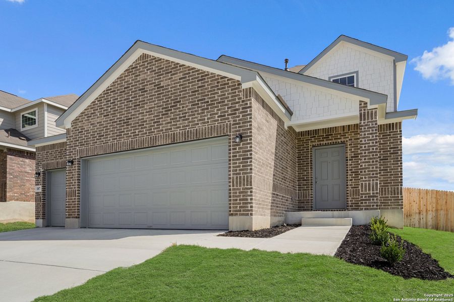Front exterior of a new home in Hunters Ranch, San Antonio, TX, highlighting curb appeal (Image 1). Front exterior of a new home in Hunters Ranch, San Antonio, TX, highlighting curb appeal (Image 1).