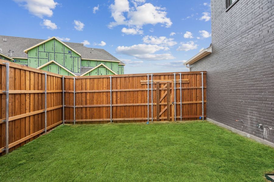 Exterior details and patio area of a home in Newman Village Townhomes, Frisco (Image 16).