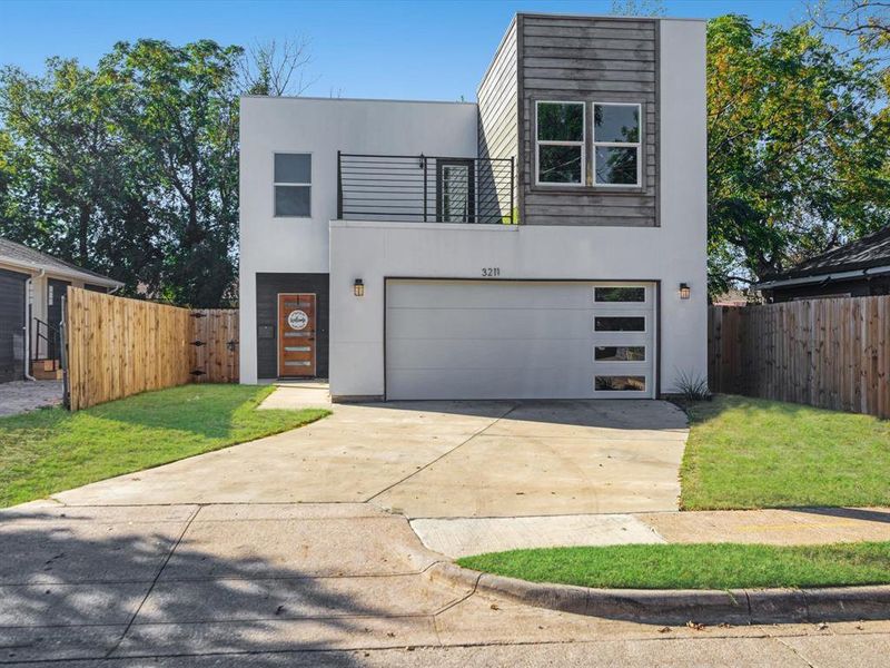 Modern home with a garage and a front lawn