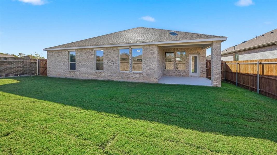 Rear view of property featuring brick siding, a patio area, a shingled roof, and a fenced backyard Rear view of property featuring brick siding, a patio area, a shingled roof, and a fenced backyard