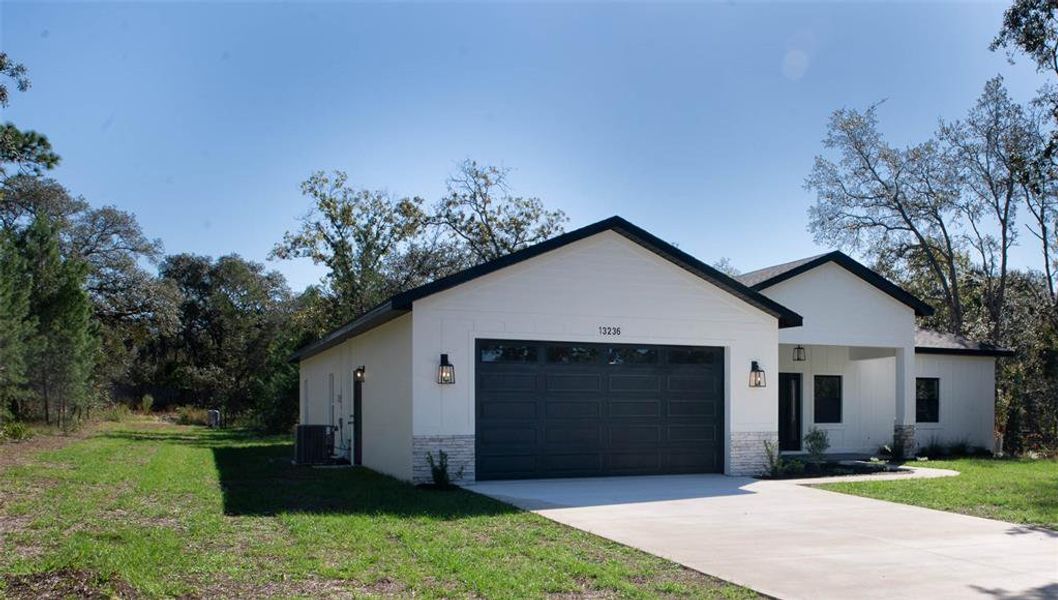 Front exterior of a new home in , Weeki Wachee, FL, highlighting curb appeal (Image 2).