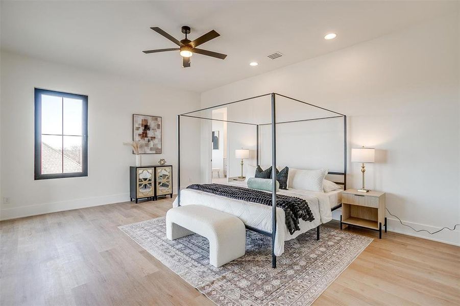 Bedroom with baseboards, visible vents, and light wood finished floors