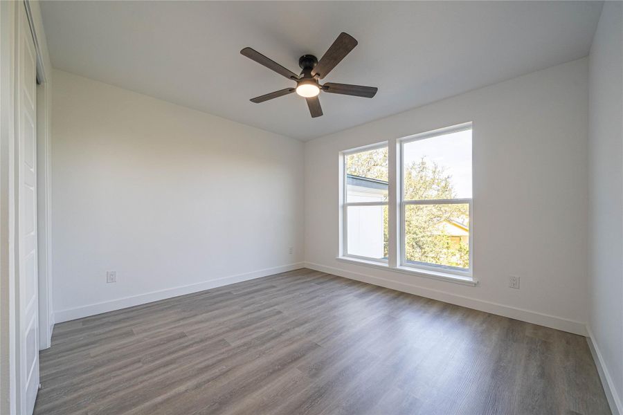Unfurnished room featuring wood finished floors and ceiling fan