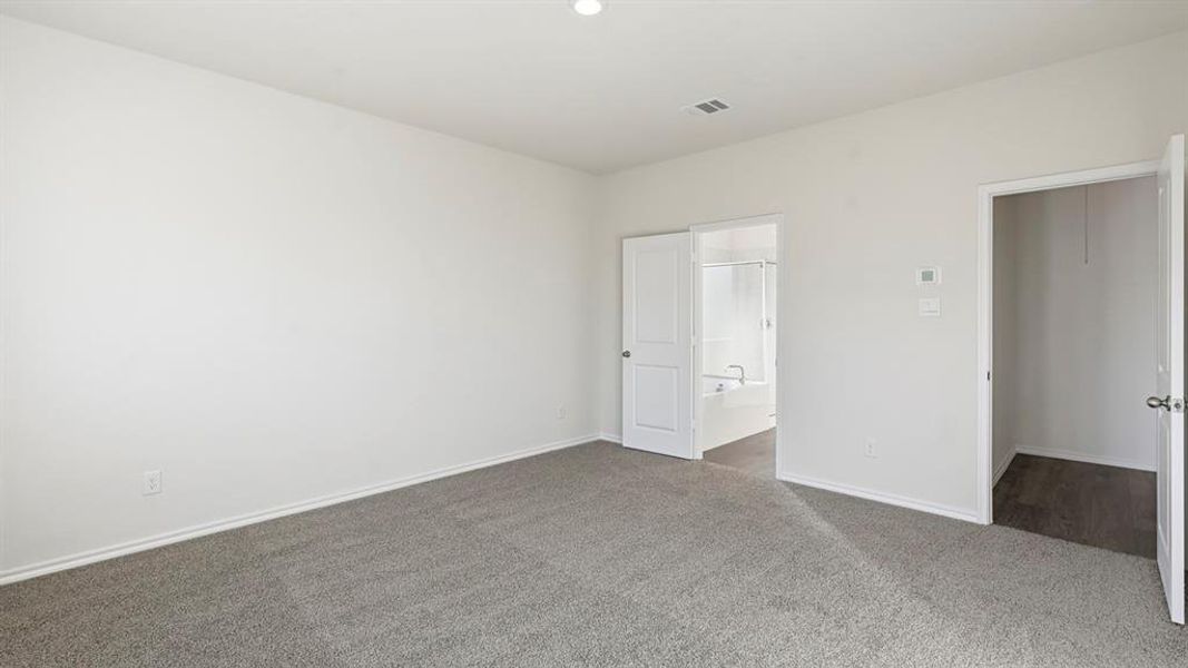 Unfurnished bedroom featuring carpet and connected bathroom