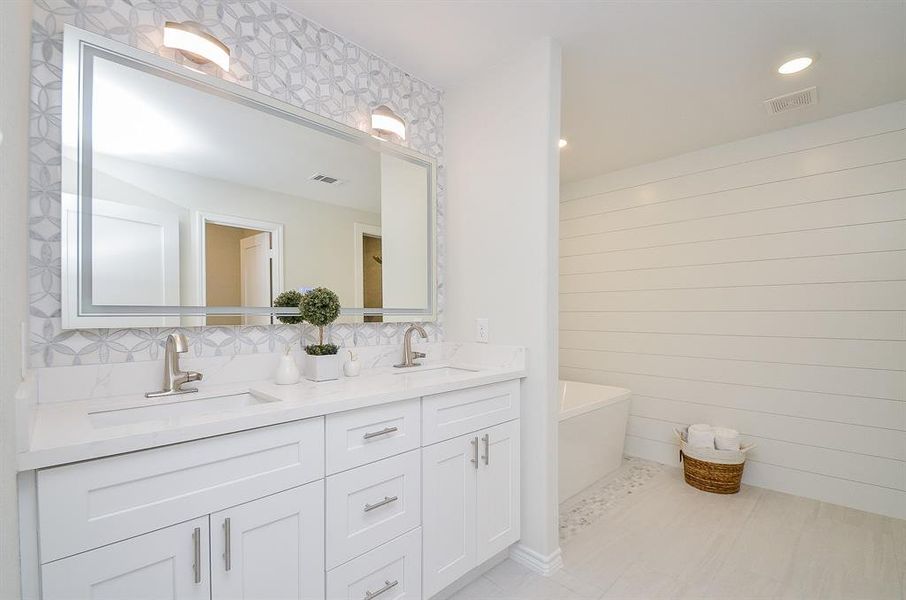 Primary bathroom:Photo is not of the actual home, but is an inspirational photo of the the builder's model and may depict options, furnishings, and/or decor features that are not included.Photos of home will be uploaded shortly.