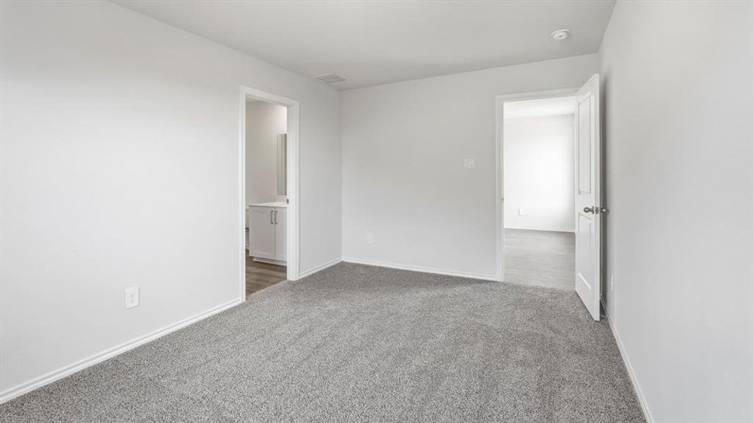 Spare room featuring baseboards and light carpet Spare room featuring baseboards and light carpet