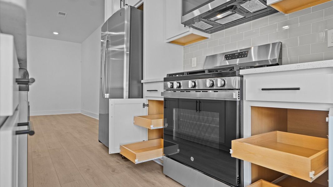 Exclusive DRB Homes kitchen with a 9-foot island, elevated finishes, and pendant lighting in a prime location Exclusive DRB Homes kitchen with a 9-foot island, elevated finishes, and pendant lighting in a prime location