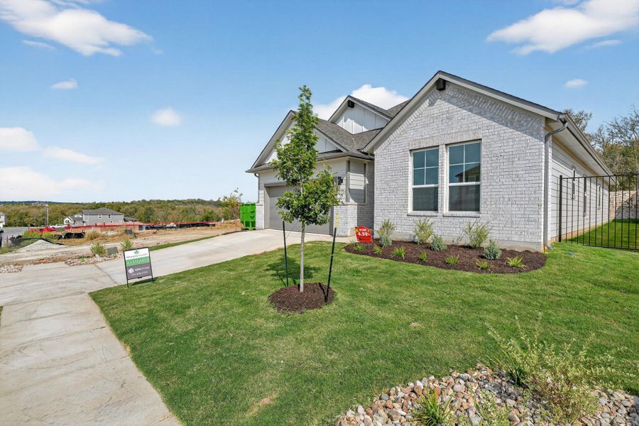View of front of property featuring brick siding, concrete driveway, a front lawn, and an attached garage View of front of property featuring brick siding, concrete driveway, a front lawn, and an attached garage