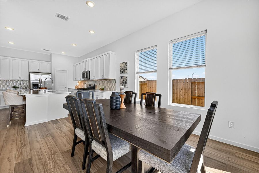 Sunlit dining area perfect for gatherings. Sunlit dining area perfect for gatherings.