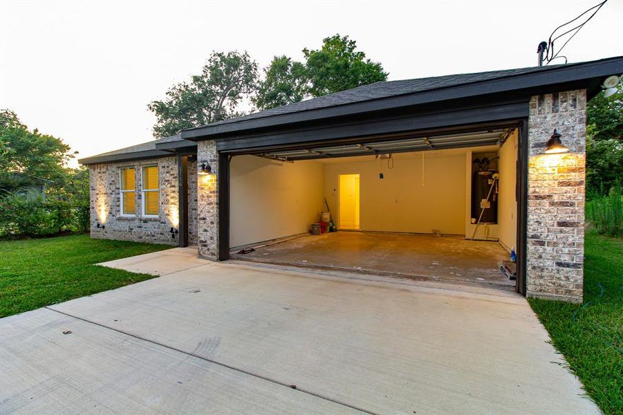 View of front facade featuring driveway, a garage, a front lawn, and brick siding View of front facade featuring driveway, a garage, a front lawn, and brick siding