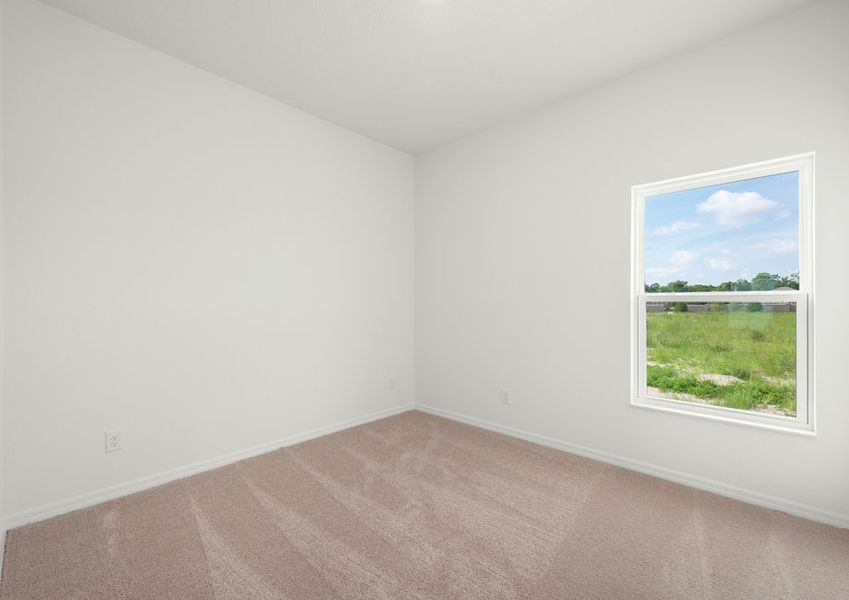 Master bedroom with lush carpet and a window that face the back yard Master bedroom with lush carpet and a window that face the back yard
