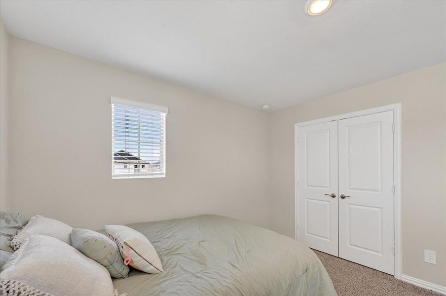 Bedroom with carpet floors and a closet