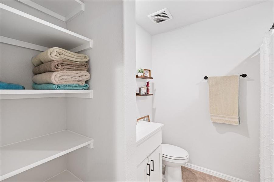 Bathroom with vanity, curtained shower, and light tile patterned floors