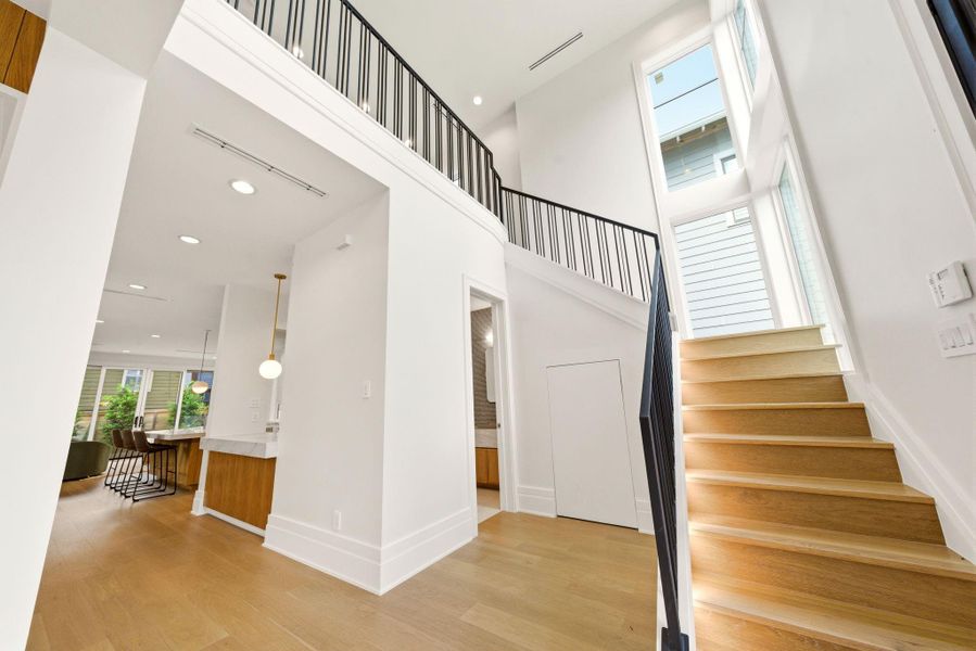 Dramatic two-story foyer filled with natural light, soaring ceilings, and stunning lit staircase. Dramatic two-story foyer filled with natural light, soaring ceilings, and stunning lit staircase.