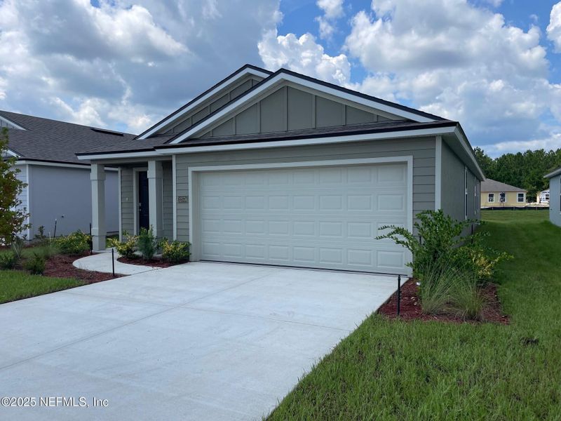 Front exterior of a new home in The Arbors, Jacksonville, FL, highlighting curb appeal (Image 29). Front exterior of a new home in The Arbors, Jacksonville, FL, highlighting curb appeal (Image 29).