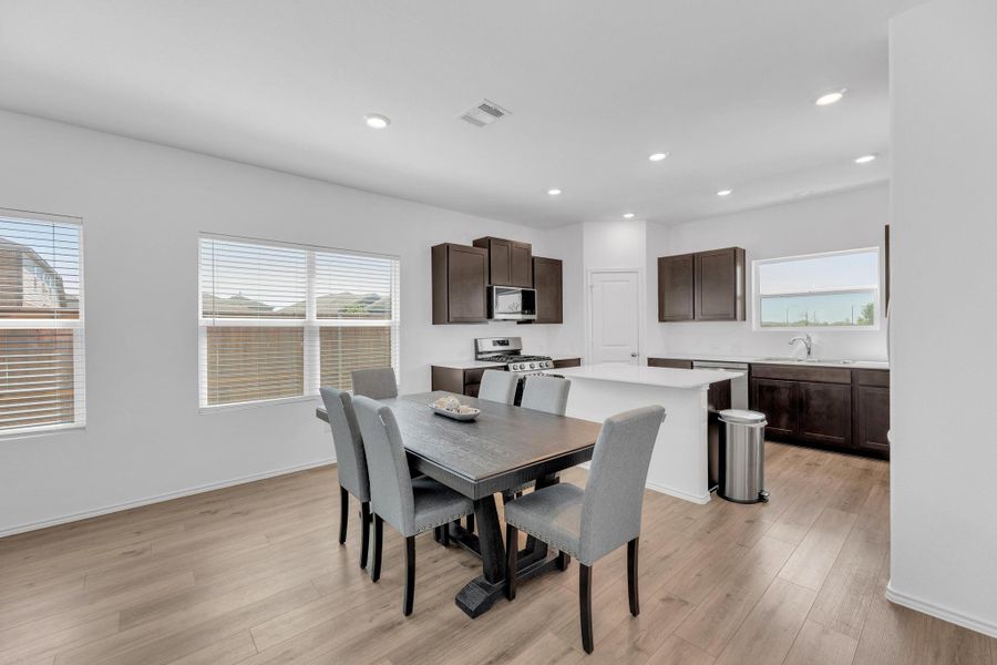 Dining room featuring visible vents, light wood finished floors, and recessed lighting