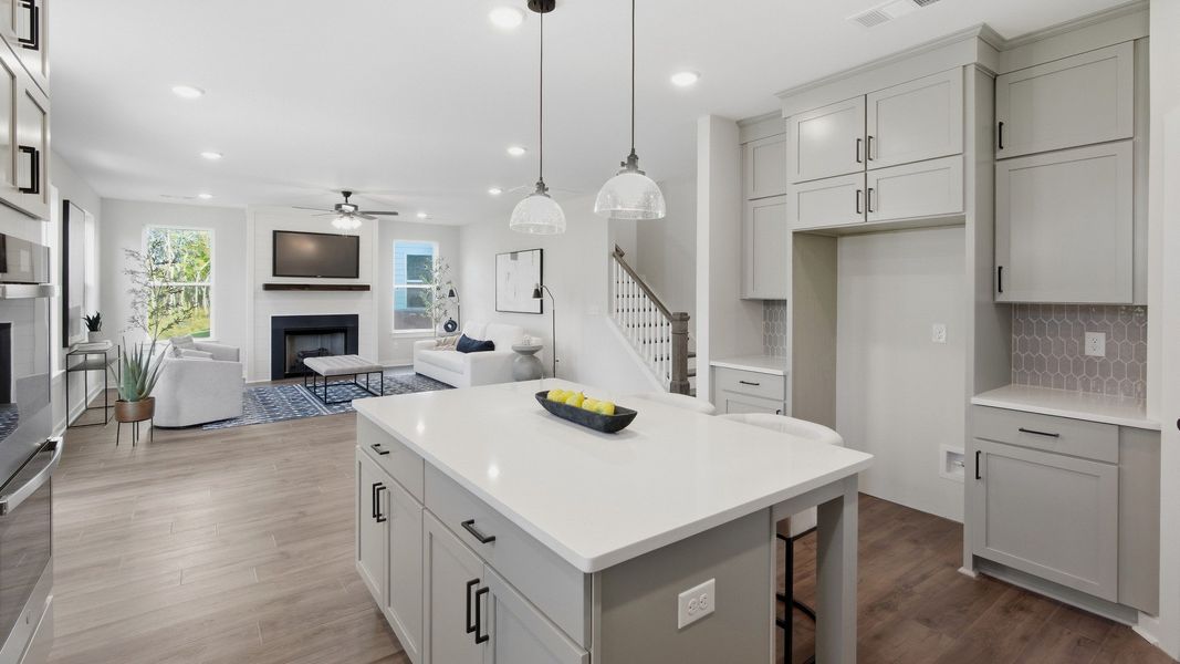 Hanging lights over kitchen island to showcase white countertops