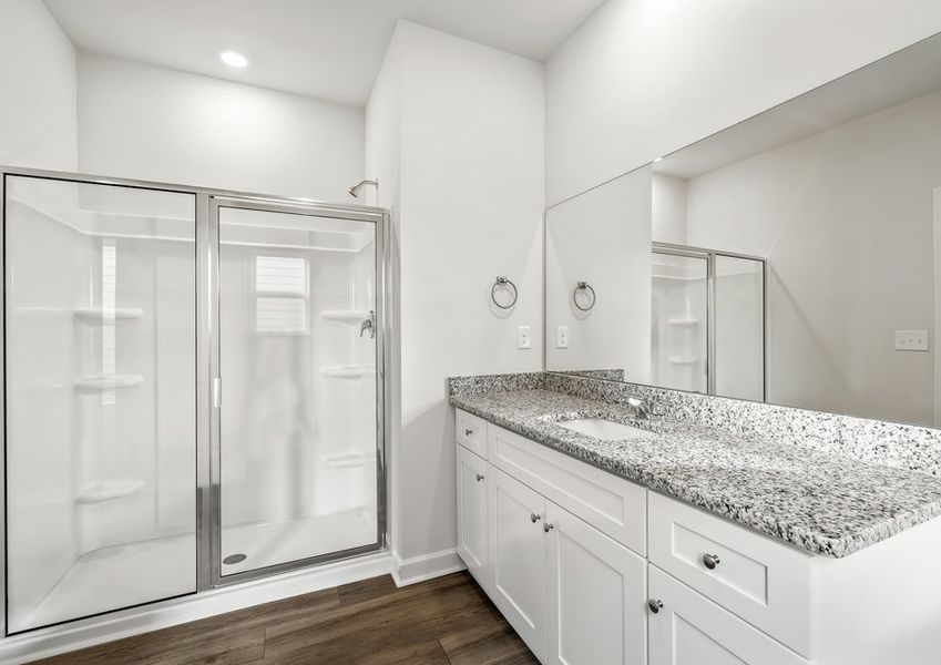 This bathroom has a glass-enclosed shower