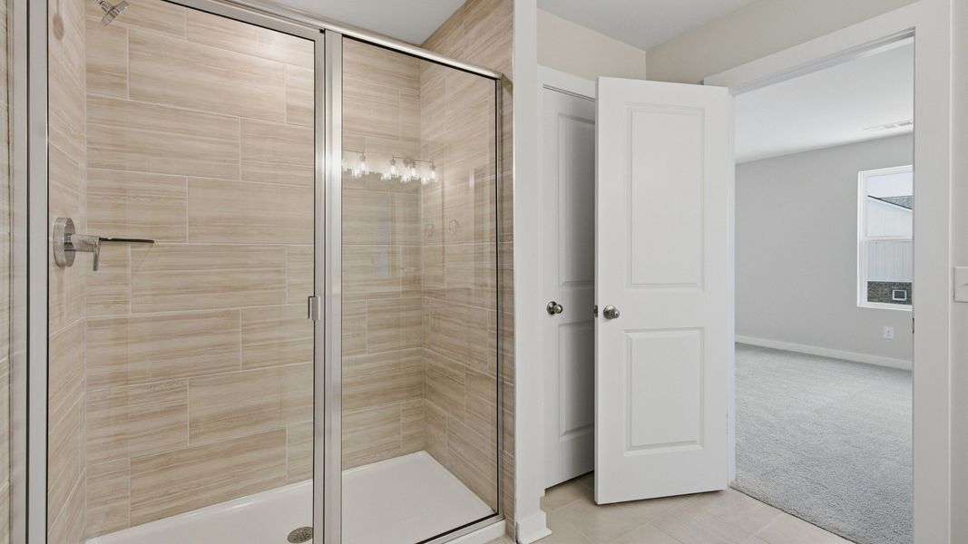 Primary bathroom connected to primary bedroom with larger shower