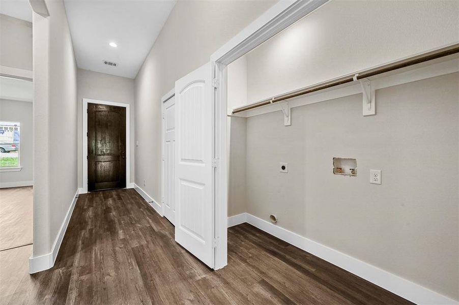 Laundry room featuring electric dryer hookup, dark hardwood / wood-style flooring, and hookup for a washing machine