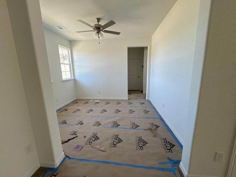 Empty room with baseboards and a ceiling fan