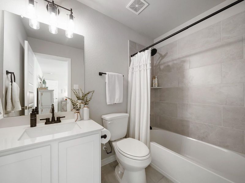 The ensuite bath is well-appointed with clean finishes and a functional layout designed for both privacy and ease.