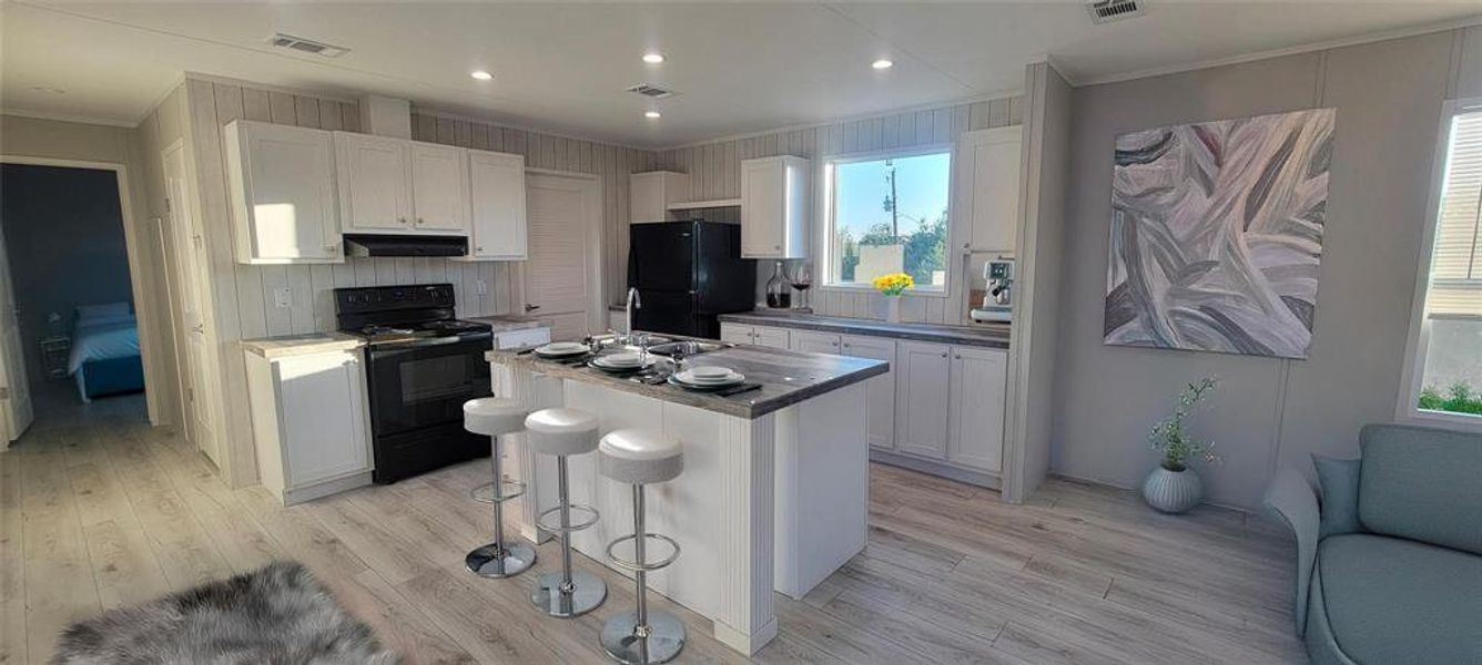 Kitchen with black appliances, white cabinets, visible vents, and light wood-type flooring