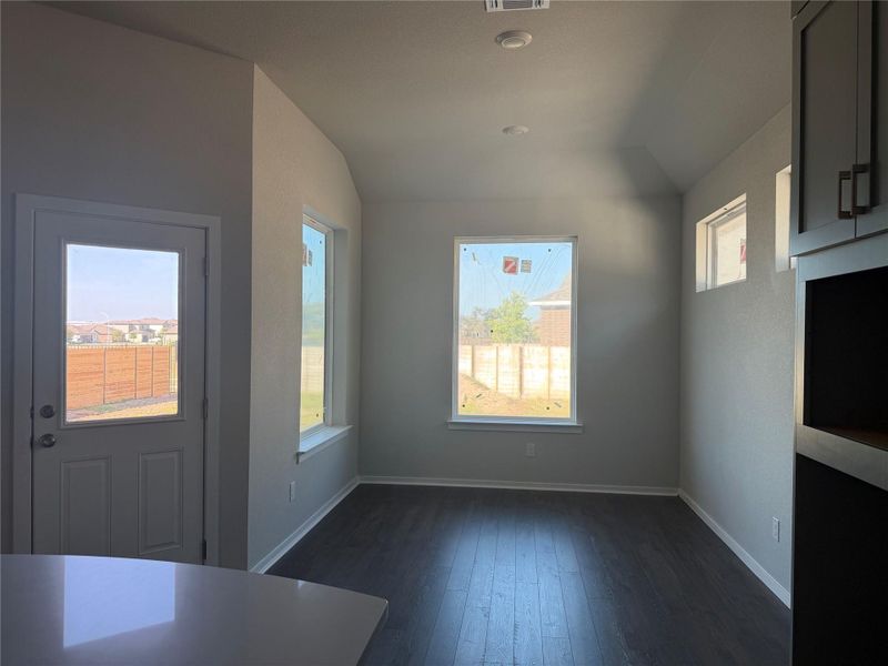 Dark wood flooring and crisp white trim define this versatile dining space.