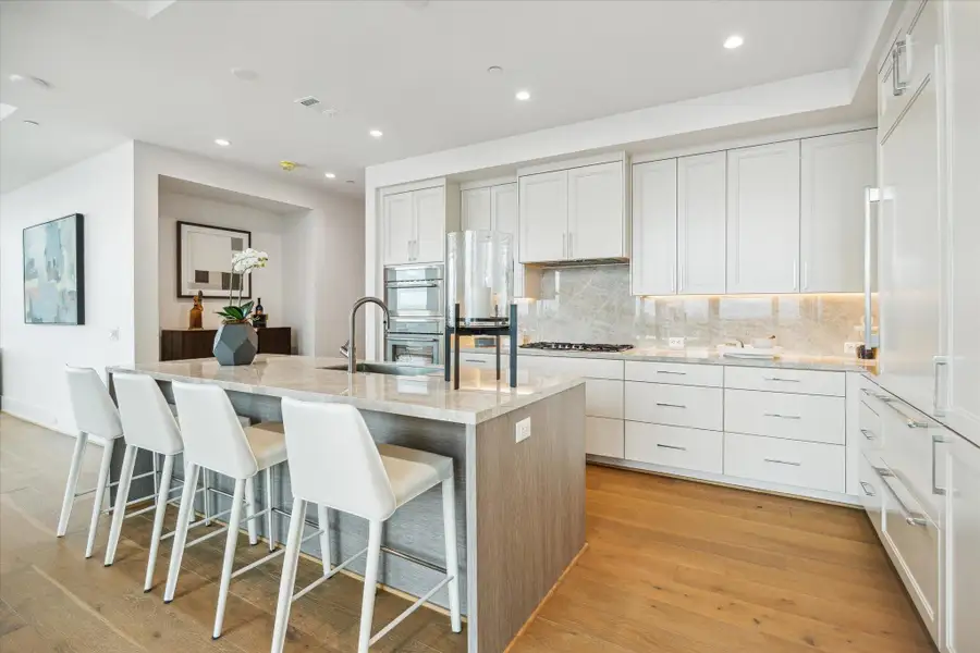 Center island features a built-in sink, and breakfast bar seating. Photos are of a similar unit with the same floor plan Center island features a built-in sink, and breakfast bar seating. Photos are of a similar unit with the same floor plan