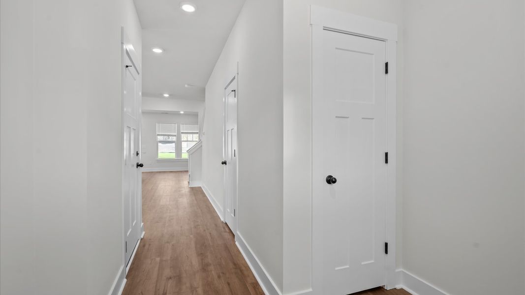 Memorable arrival experience with hardwood floors and elegant trim in the foyer