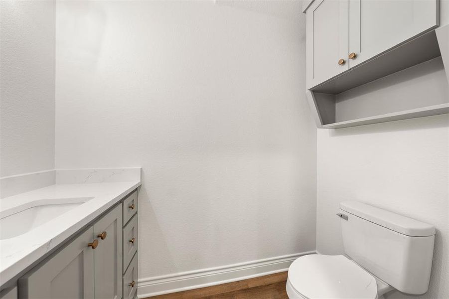Bathroom featuring vanity and dark wood-style floors Bathroom featuring vanity and dark wood-style floors