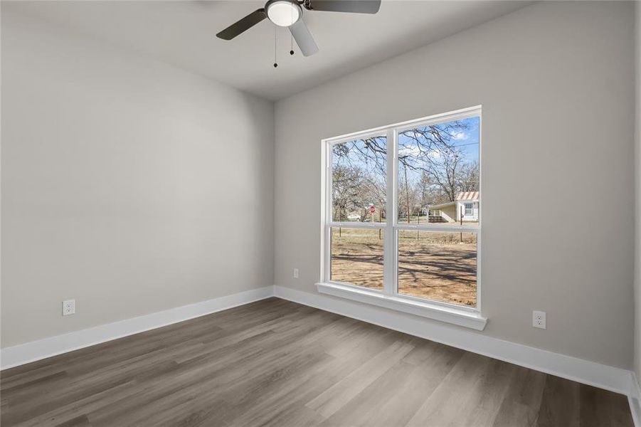 Empty room featuring ceiling fan and wood-type flooring