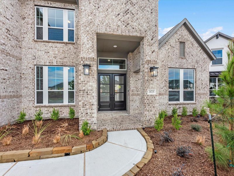 Exterior details and patio area of a home in Woodson’s Reserve, Spring (Image 3).