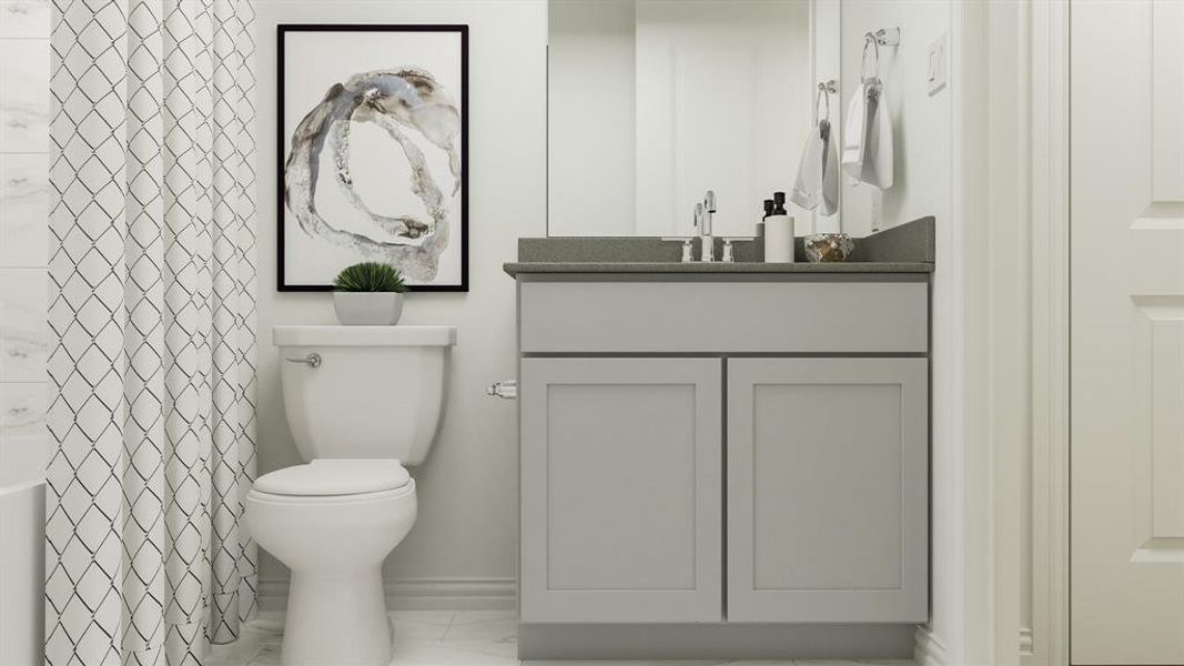 Bathroom with tile patterned floors, vanity, and toilet