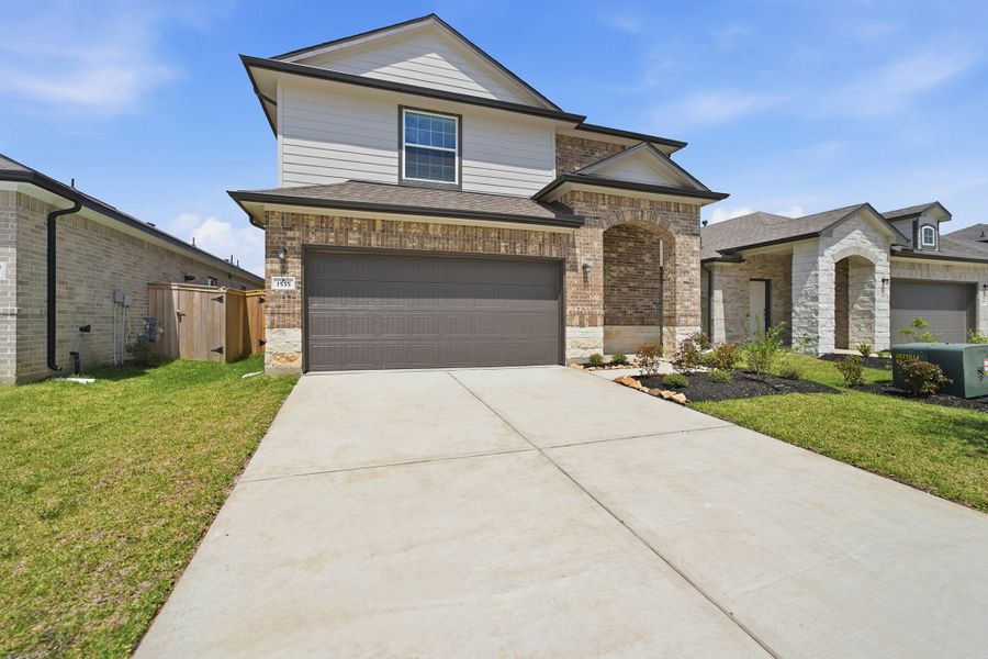 Front exterior of a new home in Windrose Green, Angleton, TX, highlighting curb appeal (Image 26).