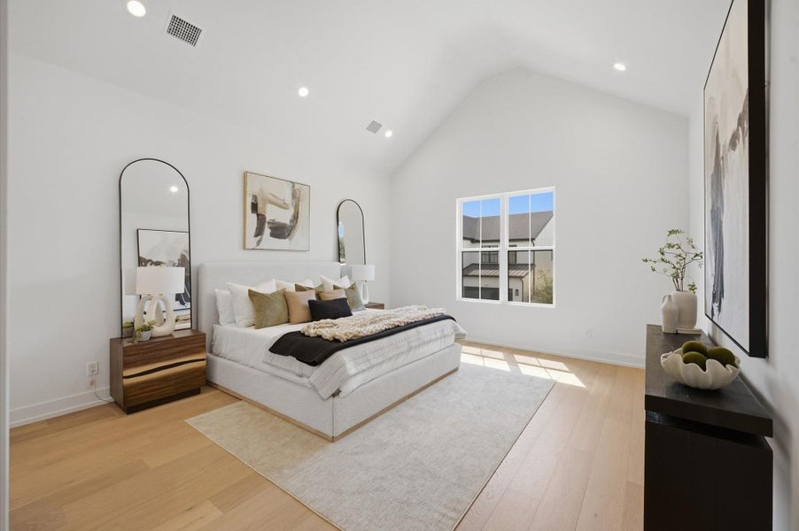 Spacious primary suite with a soaring vaulted ceiling and abundant natural light.