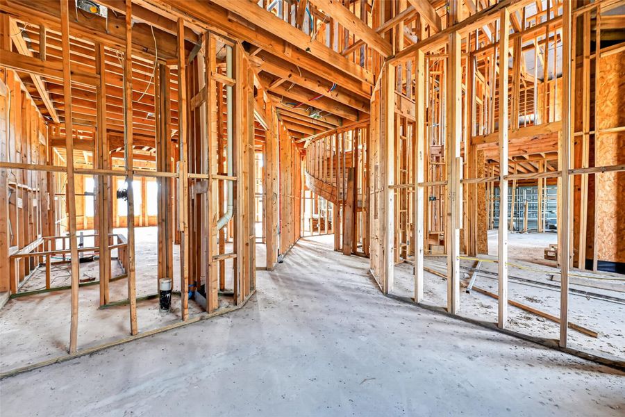 Open unfinished space showcasing framing and build progress.