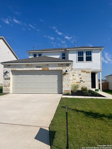 Front exterior of a new home in The Meadows at Hunters Ranch, San Antonio, TX, highlighting curb appeal (Image 2). Front exterior of a new home in The Meadows at Hunters Ranch, San Antonio, TX, highlighting curb appeal (Image 2).