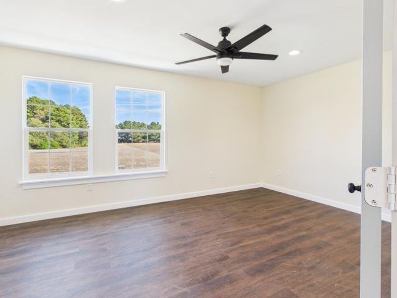 Before photofeaturing dark wood finished floors, recessed lighting, and a ceiling fan