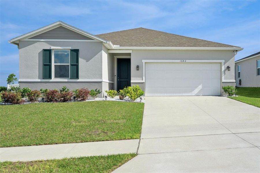 Front exterior of a new home in , Mascotte, FL, highlighting curb appeal (Image 22).